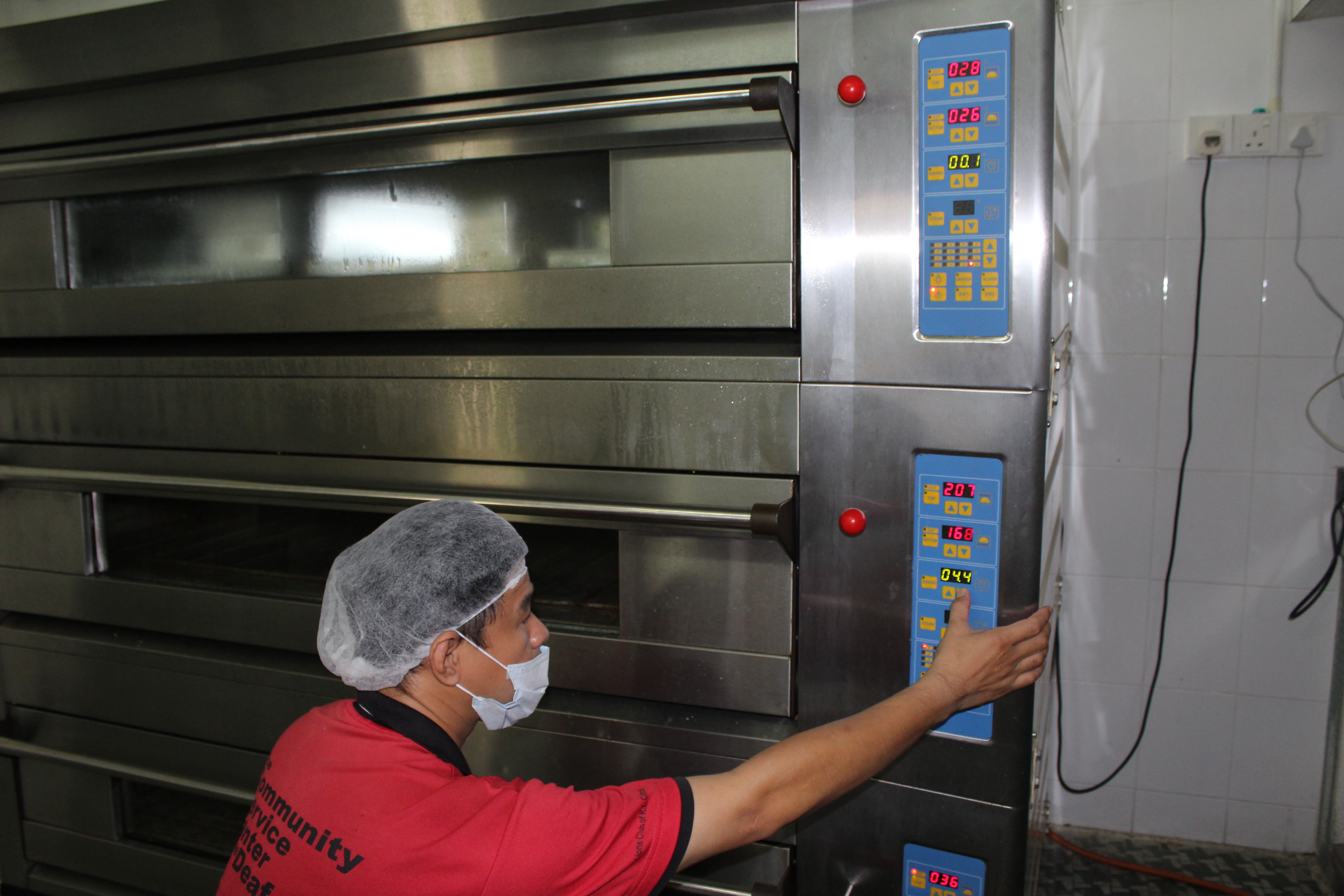 Head chef Khew Yun Loi demonstrates how the three-tier oven works.